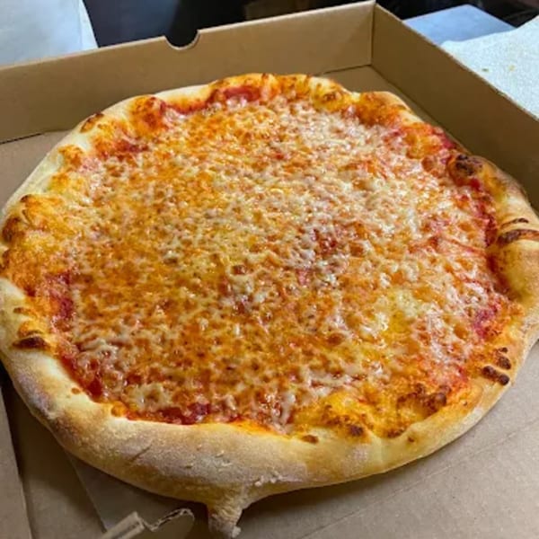 A freshly baked cheese pizza with a golden crust sits in a cardboard delivery box.